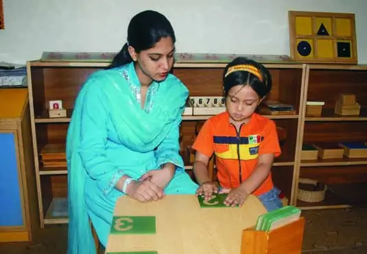 Unit 4 (M5) - Montessori Mathematics Activities - Counting till Ten - Montessori Sandpaper Numbers 2 A child working with Montessori Sandpaper Numbers.