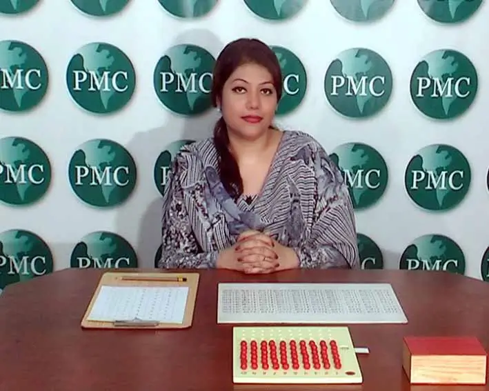 Unit 15 (M7) – Montessori Mathematics Activities – Memorization of Arithmetic Tables – Montessori Multiplication Board 2 A directress ready to present the Montessori Multiplication Board.